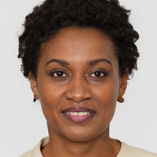Joyful black young-adult female with short  brown hair and brown eyes