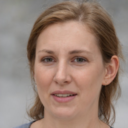 Joyful white adult female with medium  brown hair and grey eyes