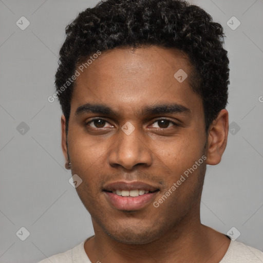 Joyful black young-adult male with short  black hair and brown eyes