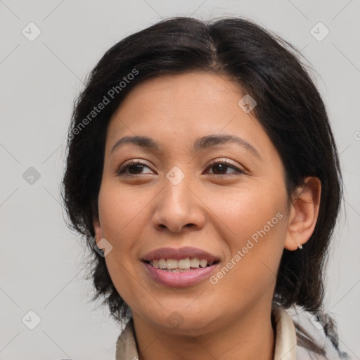 Joyful latino adult female with medium  brown hair and brown eyes