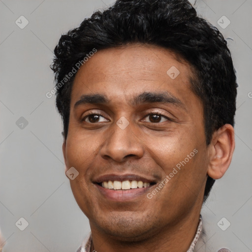 Joyful latino young-adult male with short  black hair and brown eyes