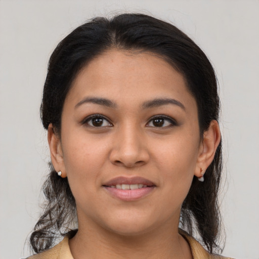 Joyful latino young-adult female with medium  brown hair and brown eyes