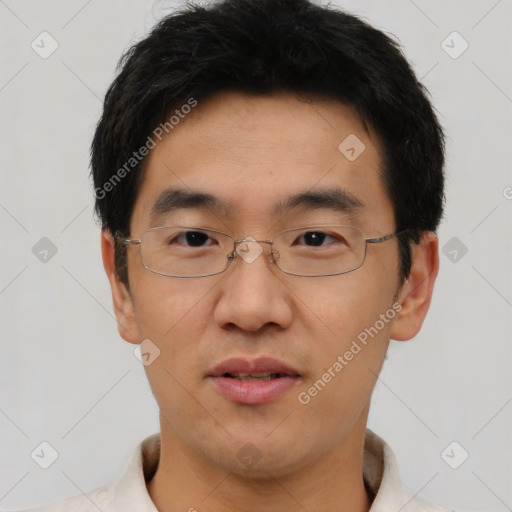 Joyful asian young-adult male with short  black hair and brown eyes