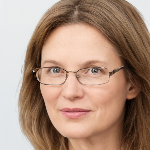 Joyful white adult female with long  brown hair and green eyes