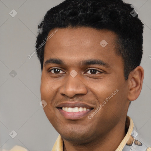 Joyful black young-adult male with short  black hair and brown eyes