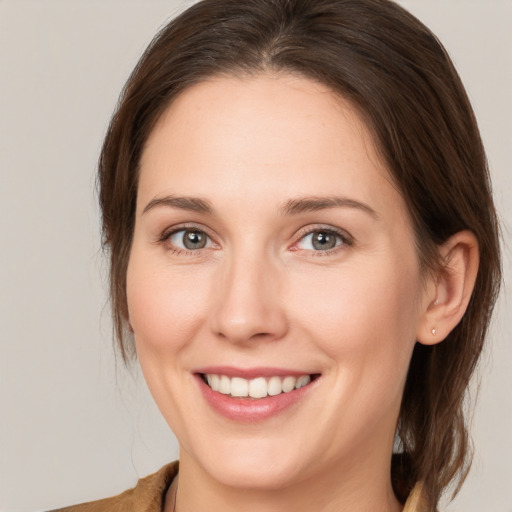 Joyful white young-adult female with medium  brown hair and brown eyes