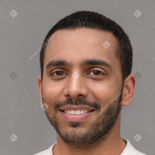 Joyful white young-adult male with short  black hair and brown eyes