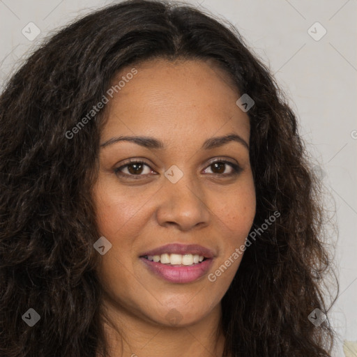 Joyful black young-adult female with long  brown hair and brown eyes