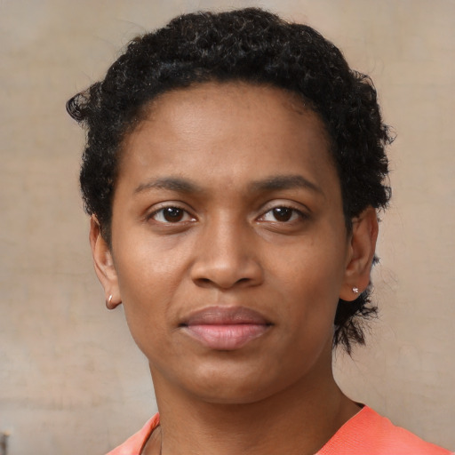 Joyful black young-adult female with short  black hair and brown eyes