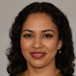 Joyful black young-adult female with medium  brown hair and brown eyes