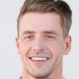 Joyful white young-adult male with short  brown hair and grey eyes