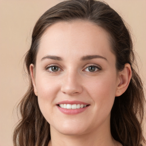 Joyful white young-adult female with long  brown hair and grey eyes