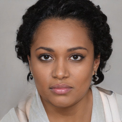 Neutral black young-adult female with medium  brown hair and brown eyes