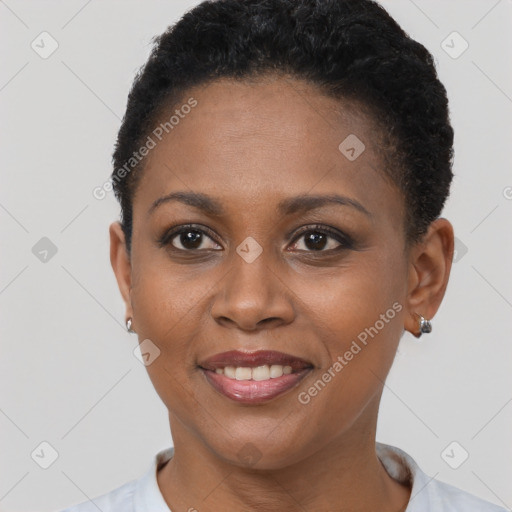 Joyful black young-adult female with short  black hair and brown eyes