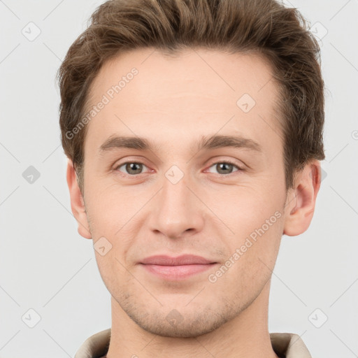 Joyful white young-adult male with short  brown hair and grey eyes