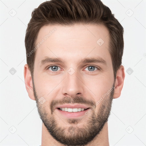 Joyful white young-adult male with short  brown hair and grey eyes