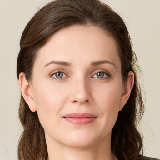 Joyful white young-adult female with long  brown hair and green eyes