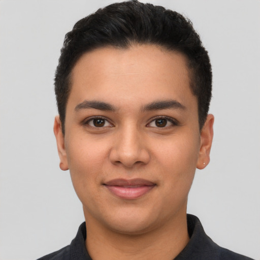 Joyful latino young-adult male with short  black hair and brown eyes