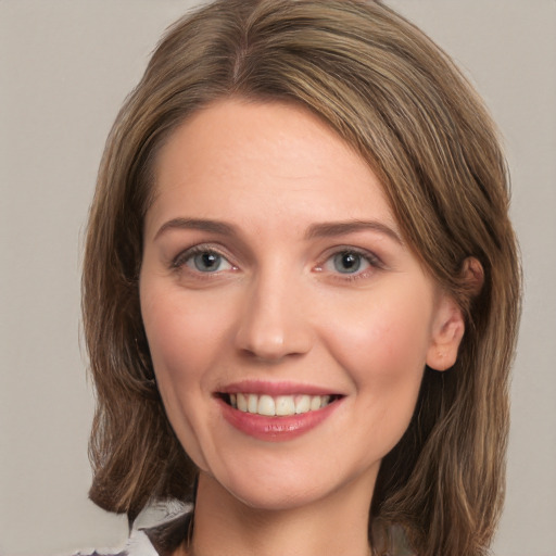 Joyful white young-adult female with medium  brown hair and green eyes