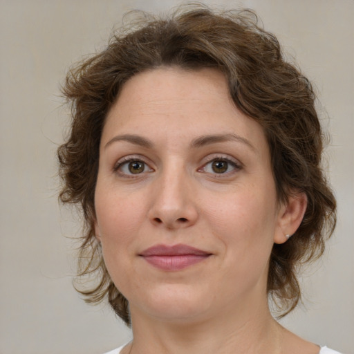 Joyful white young-adult female with medium  brown hair and green eyes