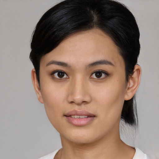 Joyful asian young-adult female with medium  black hair and brown eyes