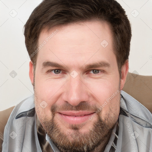 Joyful white adult male with short  brown hair and grey eyes