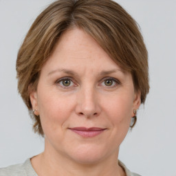 Joyful white adult female with medium  brown hair and grey eyes