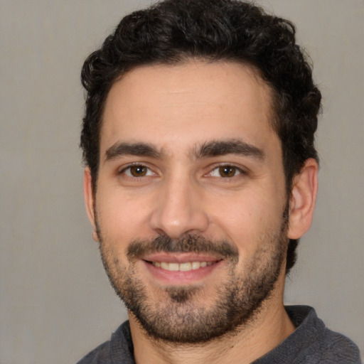 Joyful white young-adult male with short  black hair and brown eyes