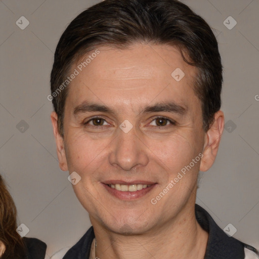 Joyful white adult male with short  brown hair and brown eyes