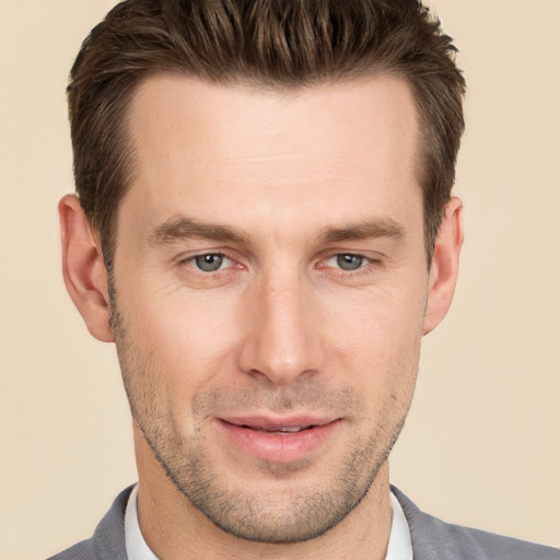 Joyful white adult male with short  brown hair and grey eyes