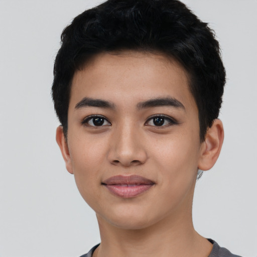 Joyful latino young-adult male with short  black hair and brown eyes
