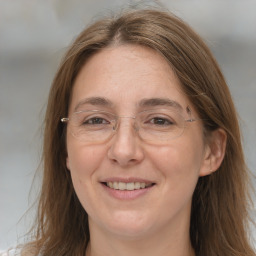 Joyful white adult female with long  brown hair and grey eyes