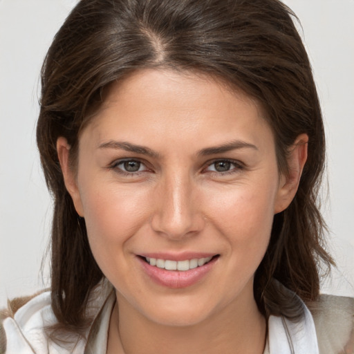 Joyful white young-adult female with medium  brown hair and brown eyes