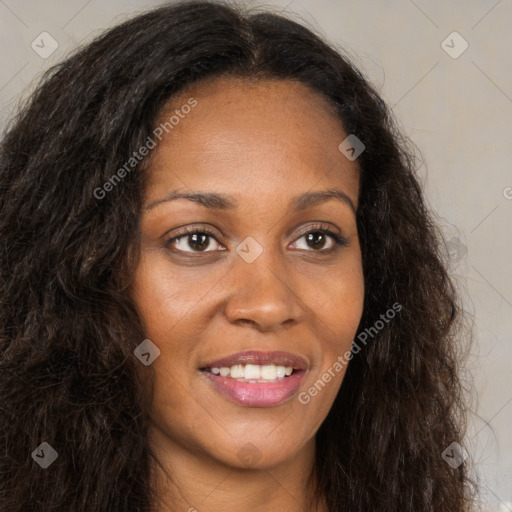 Joyful black young-adult female with long  brown hair and brown eyes