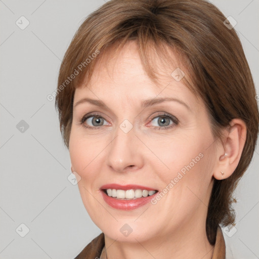 Joyful white adult female with medium  brown hair and grey eyes