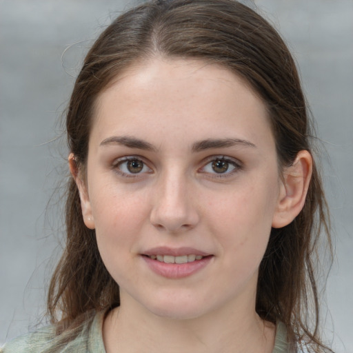 Joyful white young-adult female with long  brown hair and grey eyes