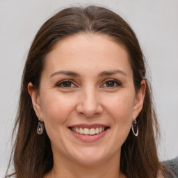 Joyful white young-adult female with medium  brown hair and grey eyes