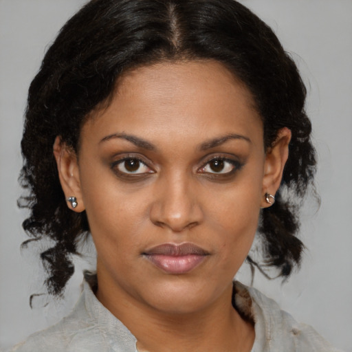 Joyful black young-adult female with medium  brown hair and brown eyes