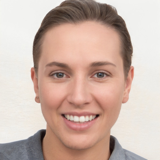 Joyful white young-adult female with short  brown hair and brown eyes