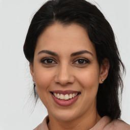 Joyful latino young-adult female with medium  brown hair and brown eyes