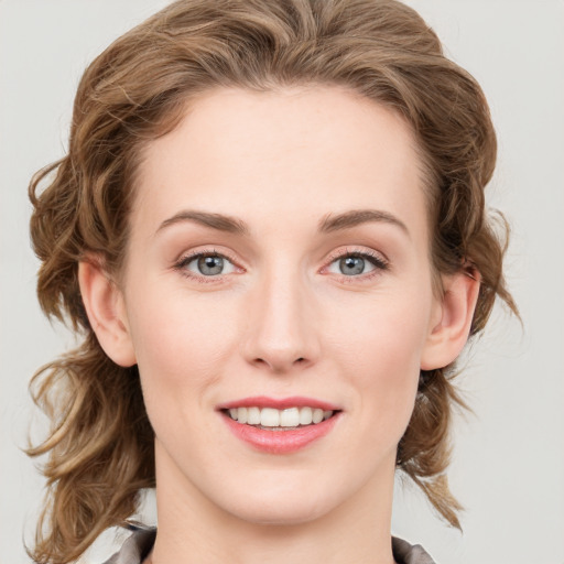 Joyful white young-adult female with medium  brown hair and blue eyes