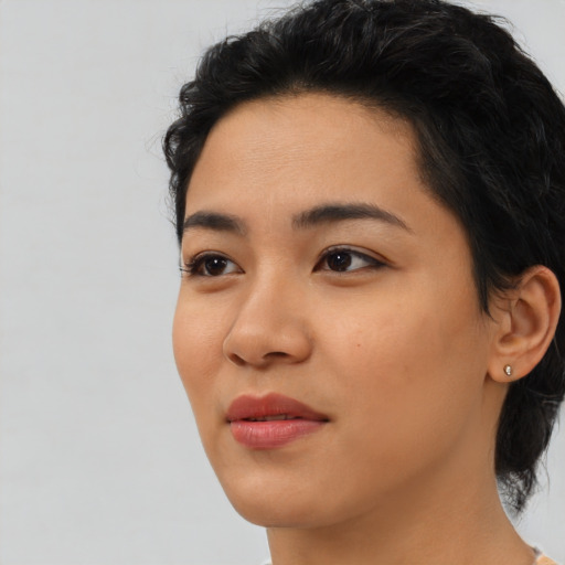 Joyful latino young-adult female with medium  black hair and brown eyes