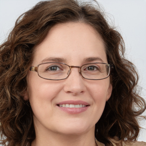 Joyful white adult female with long  brown hair and green eyes