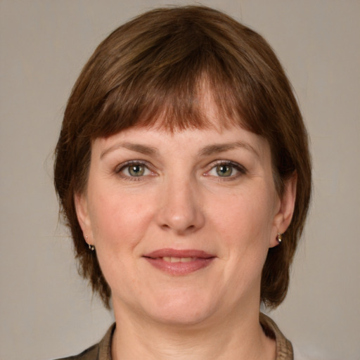 Joyful white young-adult female with medium  brown hair and grey eyes