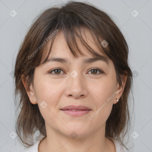 Joyful white adult female with medium  brown hair and brown eyes