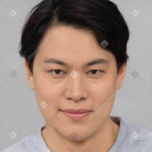 Joyful asian young-adult male with short  brown hair and brown eyes