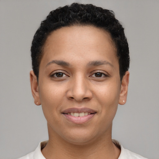 Joyful latino young-adult female with short  black hair and brown eyes