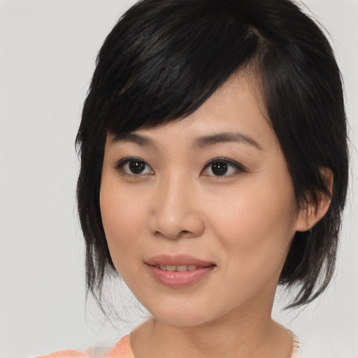 Joyful asian young-adult female with medium  brown hair and brown eyes