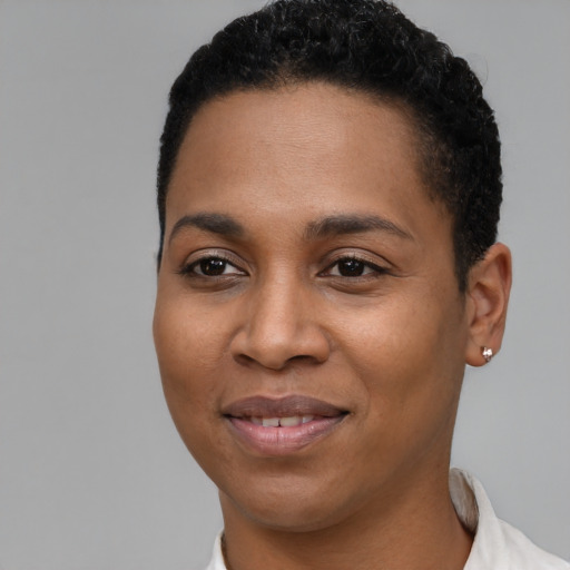 Joyful black young-adult female with short  black hair and brown eyes