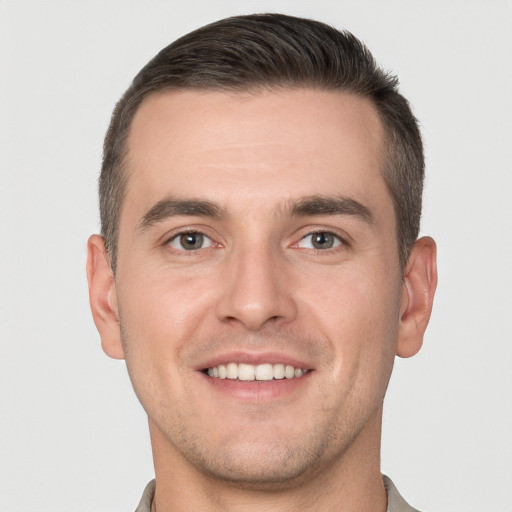 Joyful white young-adult male with short  brown hair and brown eyes